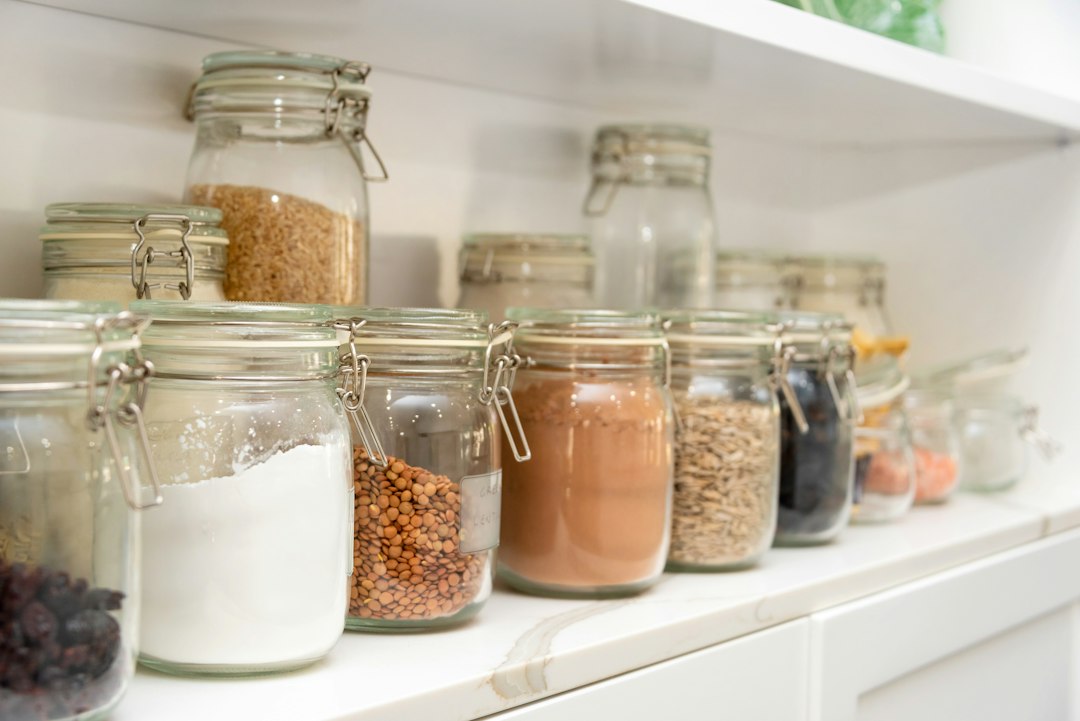 Organized pantry shelves with neatly arranged glass storage jars